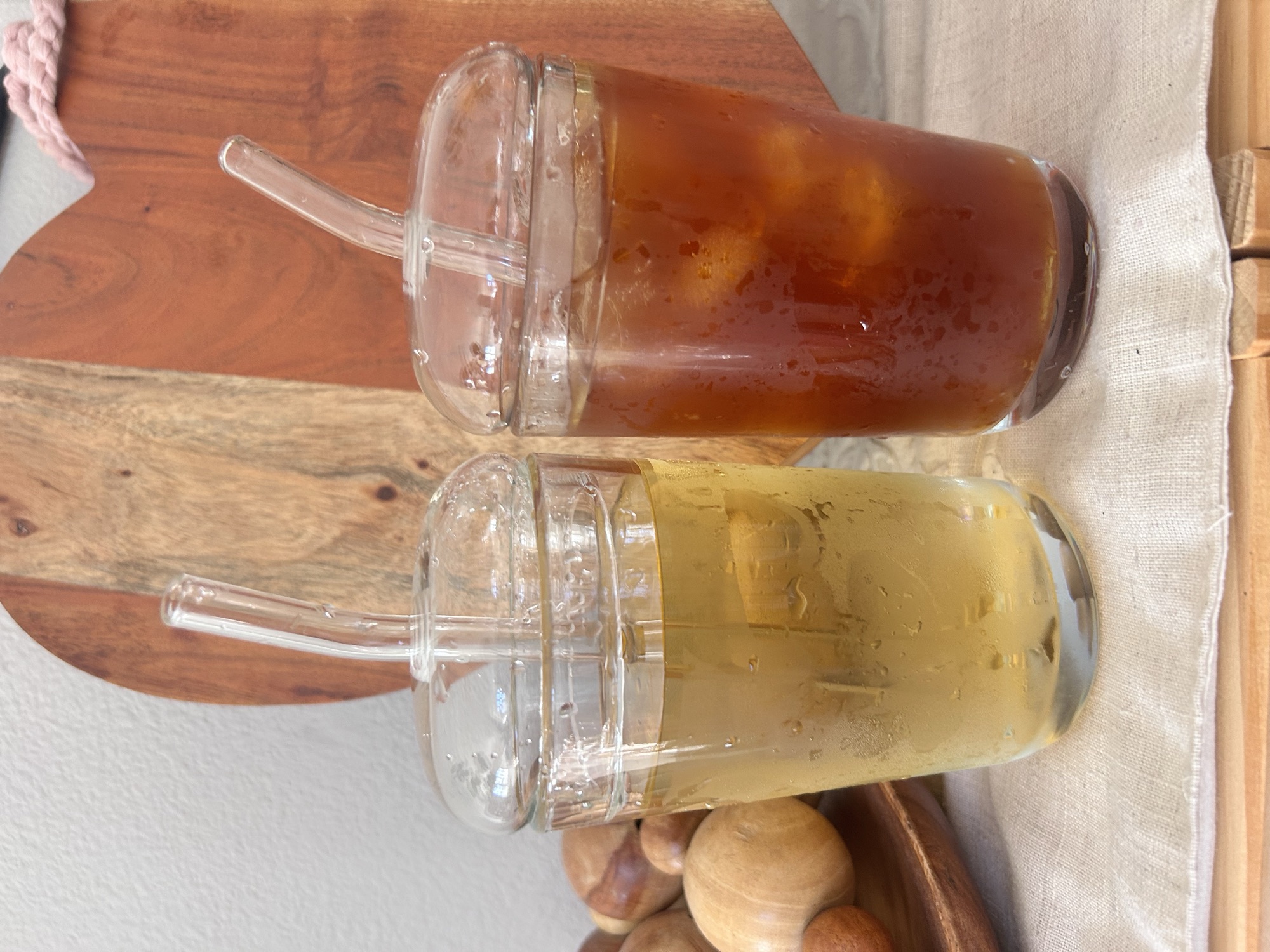 Iced soba tea. Two glasses with glass straws, one pale and one dark